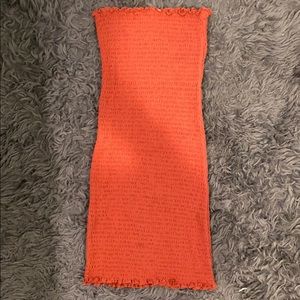Peachy colored strapless body con dress